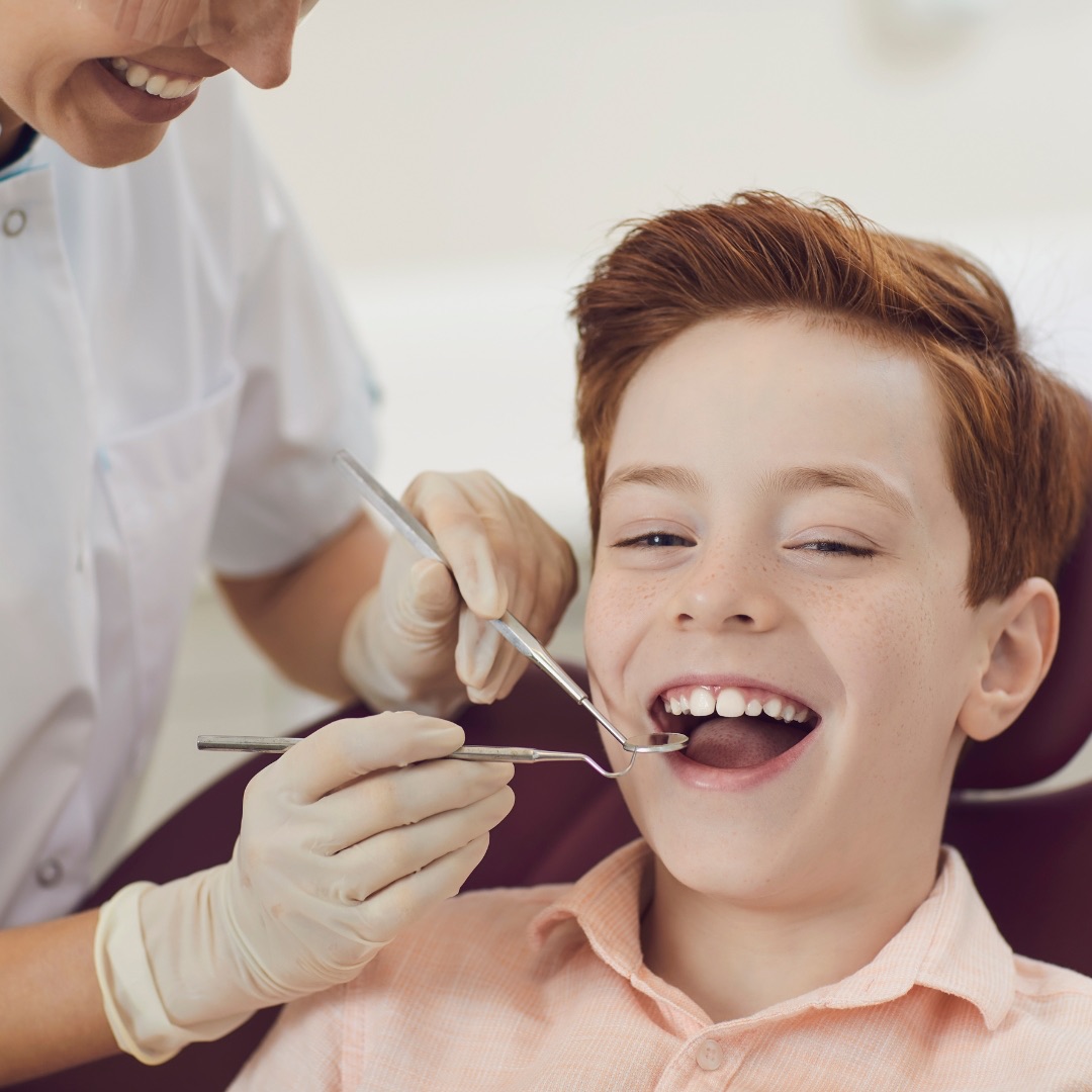A young boy having a dental check-up with a hygienist at Refresh Dental in West Edmonton